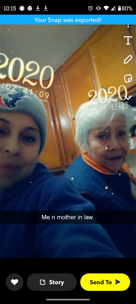 Two women smile together in a kitchen, showcasing family love and warmth during a cozy moment.