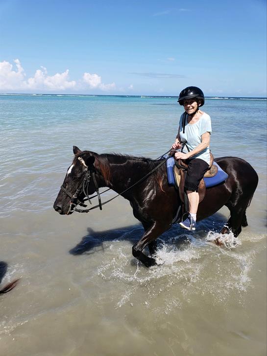 A woman riding a horse in the water