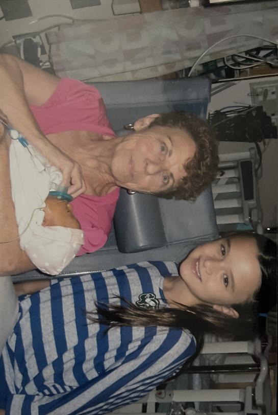 A woman and a girl posing for a picture