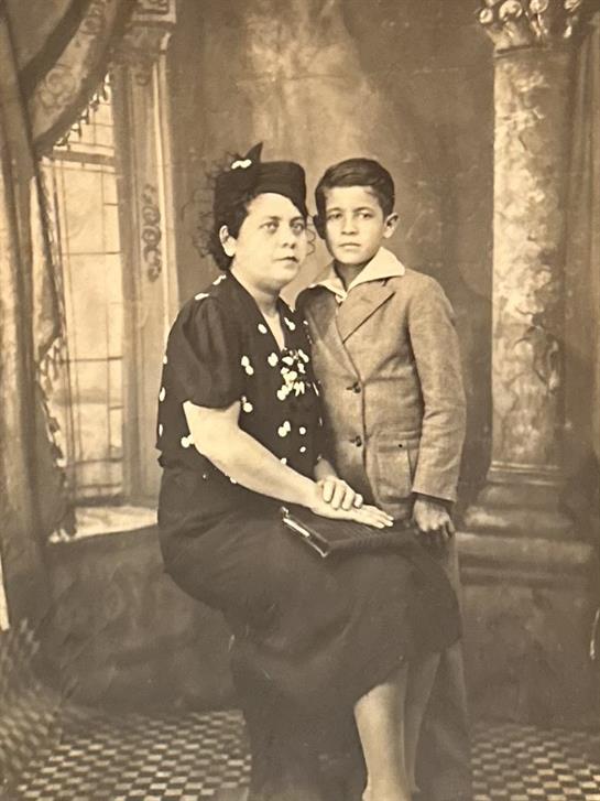 A woman and a boy posing for a picture