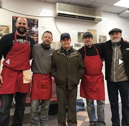 A group of men wearing aprons