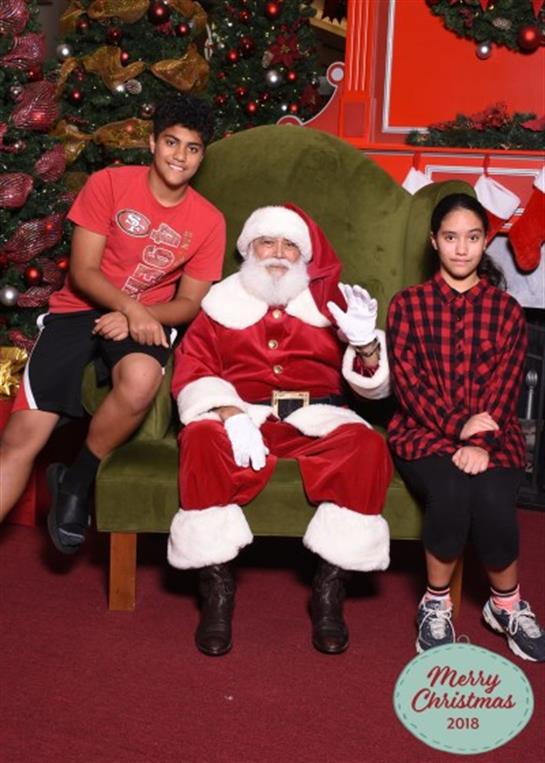 Kids enjoy a memorable moment with Santa Claus in a decorated holiday atmosphere.