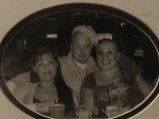 Friends sit together in a lively bar, smiling and enjoying drinks during a fun night out.