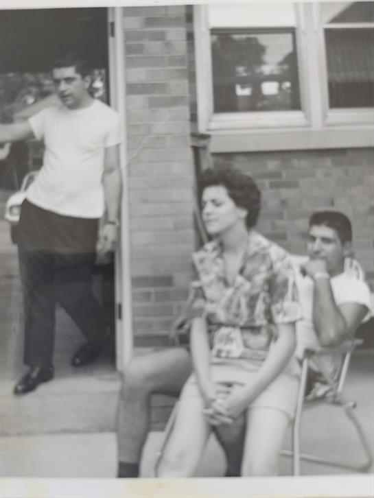 A group of people sitting outside a building