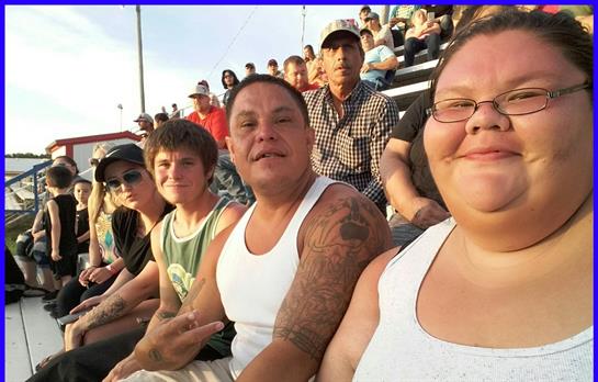 Gathering of friends and family enjoying each other's company at an outdoor event during summer.