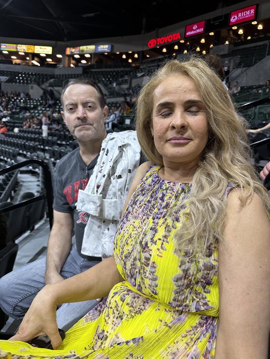 A man and woman sitting in a stadium