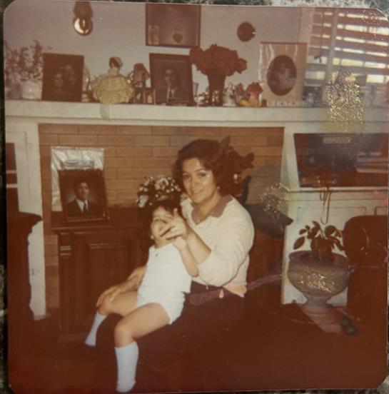 A grandmother playfully interacts with her grandchild in a warm, inviting home atmosphere.