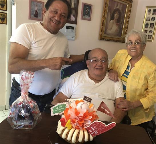 Family members gather around to celebrate a birthday in a warm home environment filled with joy.