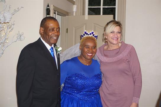 Guests smile happily, dressed in formal attire, celebrating a special wedding event together.