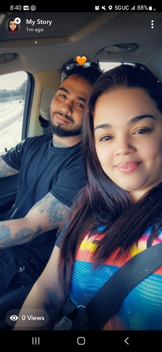 A smiling couple relaxes in a car, enjoying each other's company while traveling.