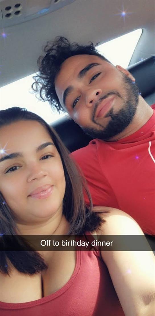 Two people are smiling happily as they sit together in a car, enjoying their time.