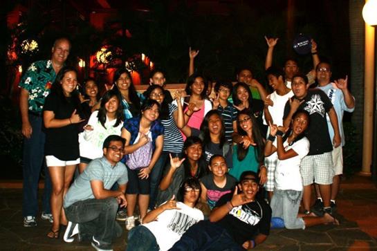 Friends gather in a lively atmosphere at night, showcasing their excitement and camaraderie.