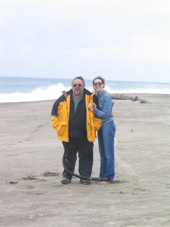 A man and woman standing on a beach