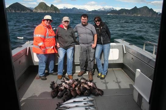 A group of people posing for a photo on a boat