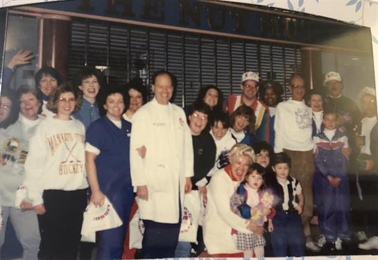 A large group celebrates together, showing joy and camaraderie at a local gathering.