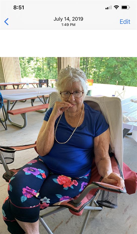 An older woman sitting in a chair