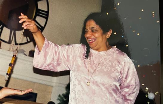 A woman enjoys a lively moment, dancing and celebrating with family during a special occasion.
