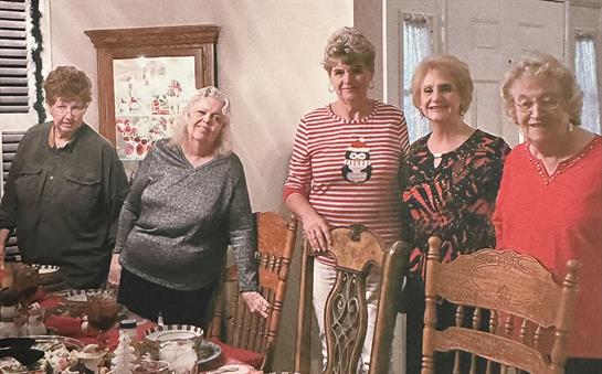 Four friends enjoy a warm afternoon together at a cozy home, sharing laughter and memories.