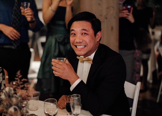 Group of people enjoying drinks and celebrating happiness at a lively indoor event.