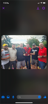 Group of friends enjoying drinks and laughter during a backyard barbecue in summer.