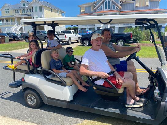 A group of people on a golf cart