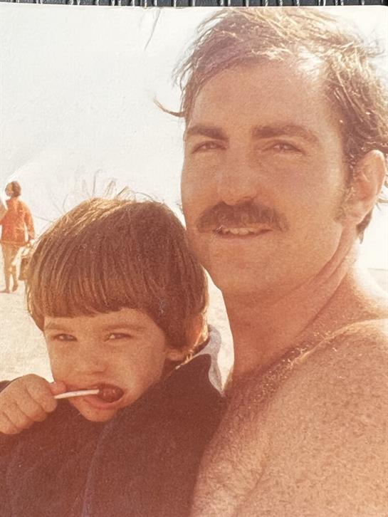 A man and child on a beach