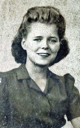 A woman with dark hair wearing a green shirt