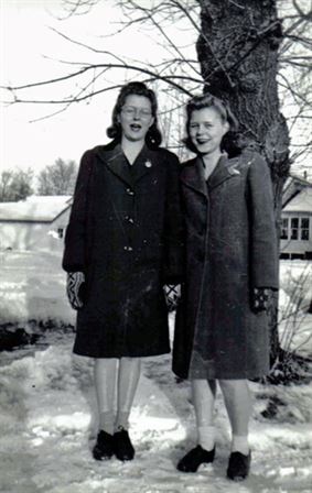 Two women standing in the snow