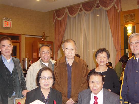 Friends enjoy each other's company and celebrate a special occasion in a warm restaurant setting.