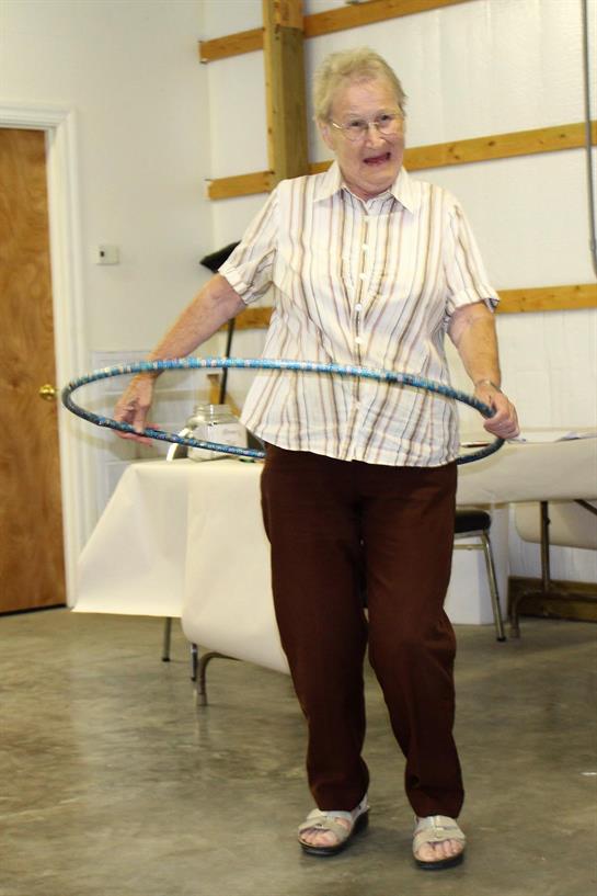 An old woman holding a hula hoop