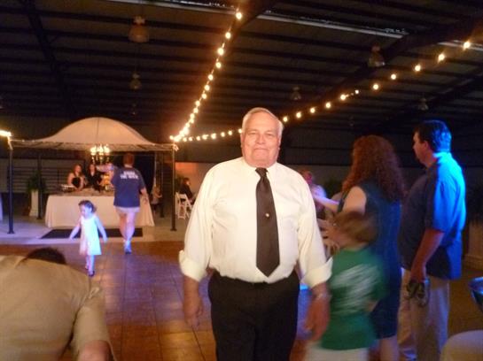 A man in a tie and tie walking in a dance floor