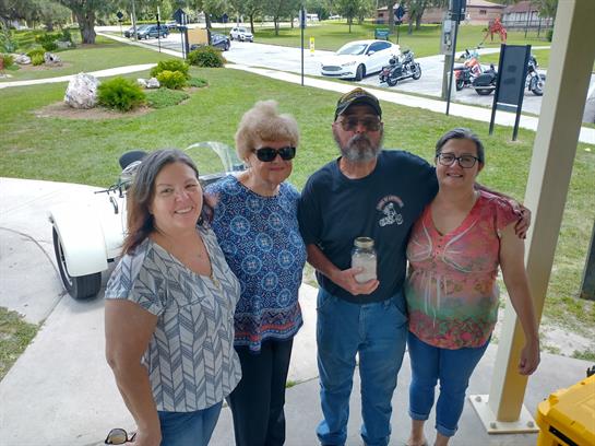 A group of people standing on a sidewalk