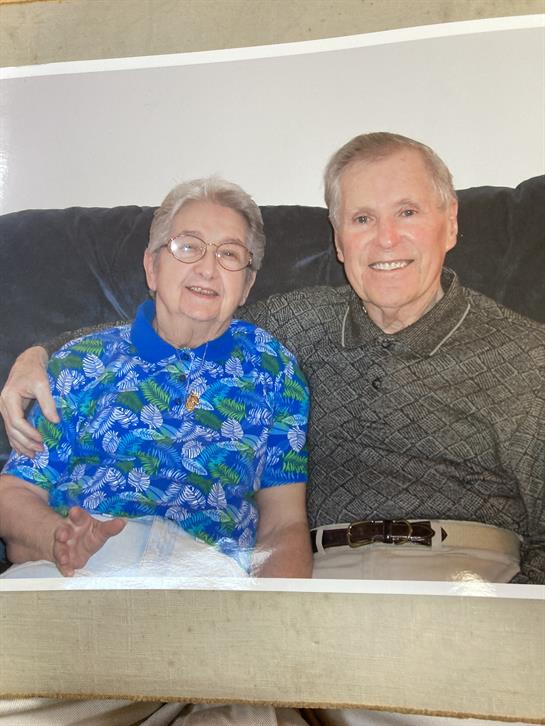 An older couple sitting on a couch