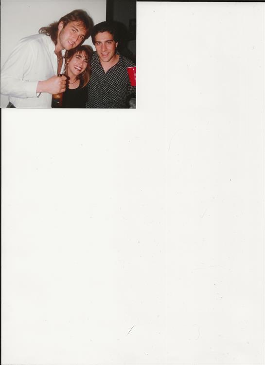 Group of friends enjoying each other's company while holding drinks at a casual gathering.