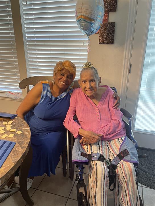 Two women sitting in a wheelchair