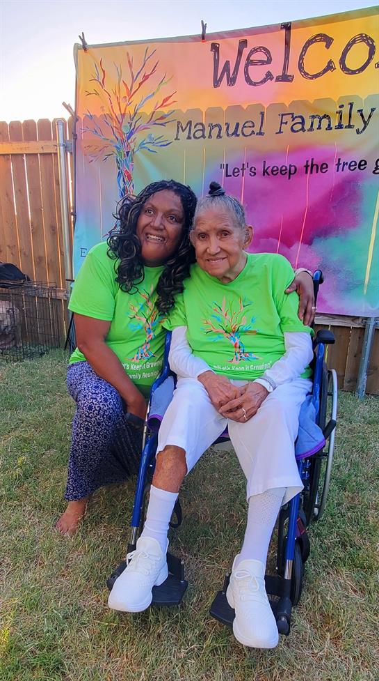 Two women in a wheelchair posing for a picture