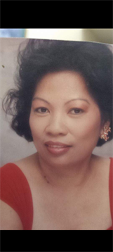 A woman displays confidence and warmth, wearing elegant jewelry against a softly lit backdrop.