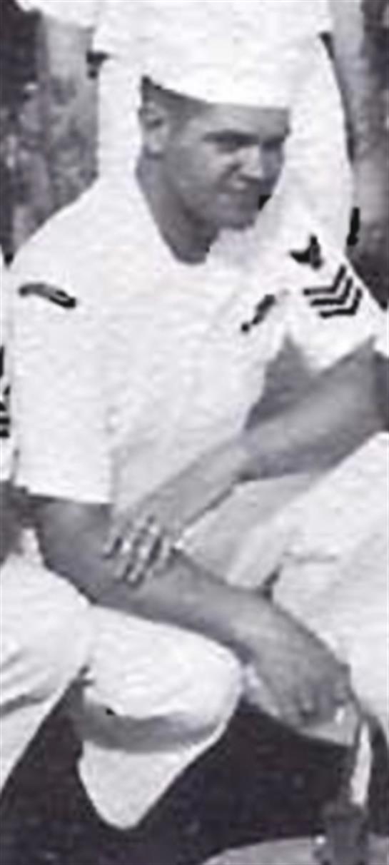 Navy officers collaborate and share a light moment during a training exercise at a naval base.