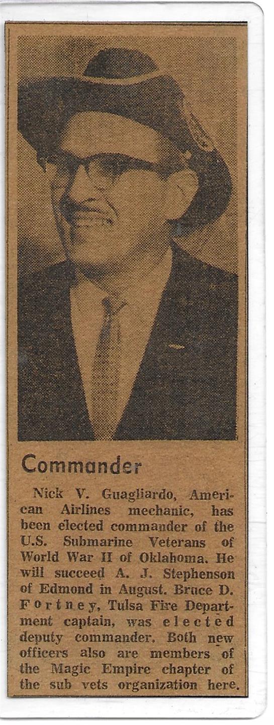 Commander Nick V. Guagliardo stands proudly in formal attire during an award ceremony.