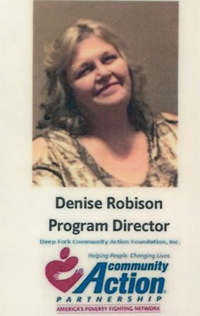 A woman smiling with a name tag