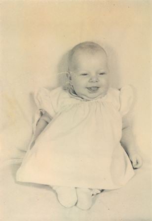 A baby in a white dress
