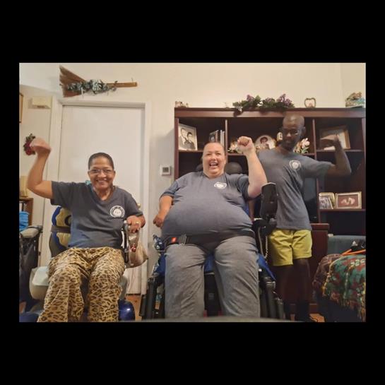 Fitness session participants lift weights at a community center to boost strength and health.