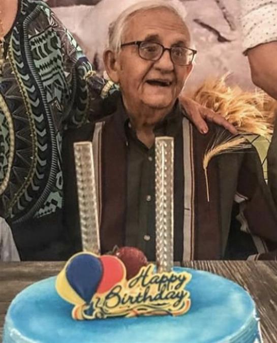 Loved ones gather to celebrate a special birthday with cake, smiles, and joy.