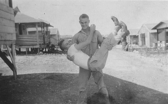A man holding a man in his arms