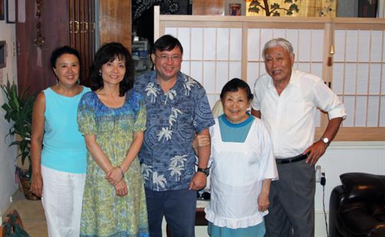 A joyful family poses in traditional attire, celebrating their bond together.