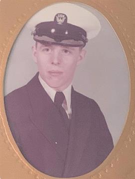 A young man poses in naval uniform, showcasing pride and discipline from the mid-20th century.