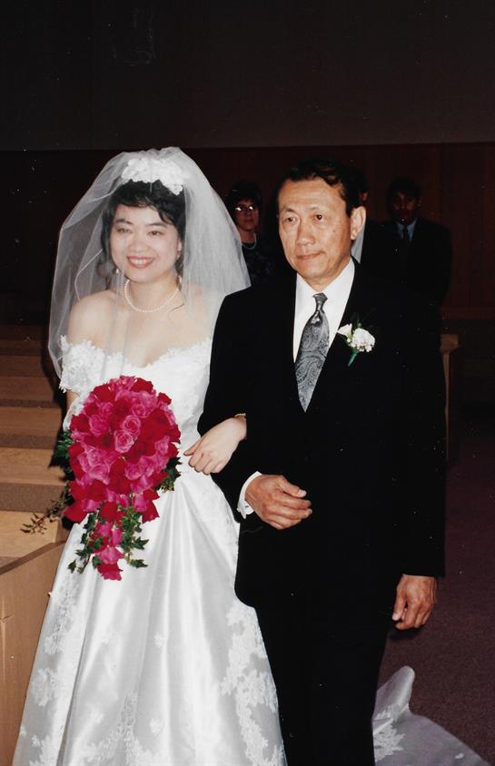 A joyful bride and her father share a tender moment walking down the wedding aisle.