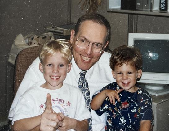 A man and two boys posing for a picture