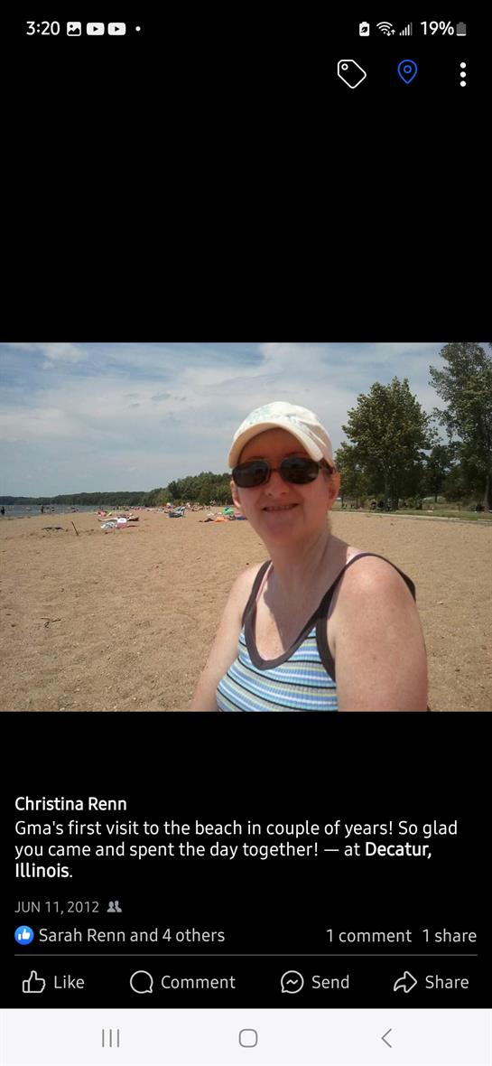 Enjoying a sunny day at the beach, posing with a smile by the water's edge in Decatur.