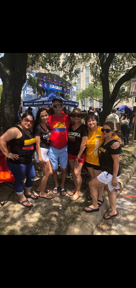 Group of friends gathers in summer heat, showcasing their fun outfits and cheerful expressions.